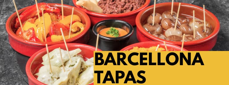 Fotografia di diverse tapas mette in ciotole piccole rosse con un condimento in un'altra ciotola nera al centro e rettangolo arancione in basso a destra con scritta Barcellona Tapas